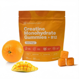 Vybrance Labs Citrus Mango Creatine Monohydrate Gummies with B12 pouch beside a whole orange, fresh mango and gummy cubes